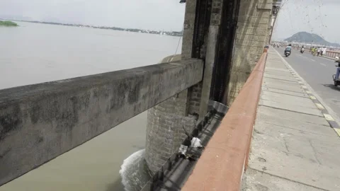 Exploring the Structural Beauty of a Seaside Bridge Over a Calm River Stock Footage 324064396