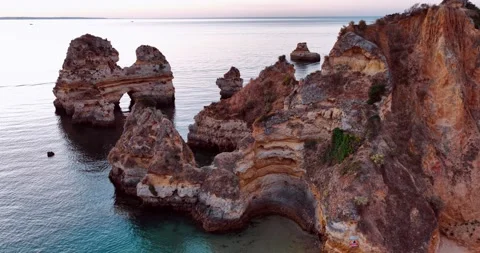 Exploring stunning coastal rock formations in Portugal at sunset Stock Footage 312326782