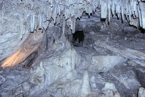 Exploring the stunning formations in a natural cave at twilight Stock Photos