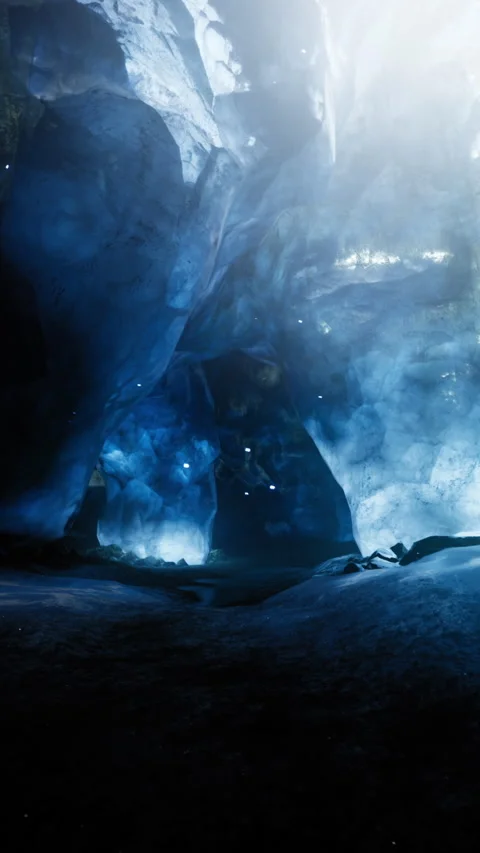 Exploring a stunning ice cave with vibrant blue light and rocky formations Stock Footage 317960825