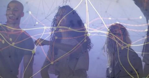 Exploring team of four collaborating under digital network projection in dim Stock Photos
