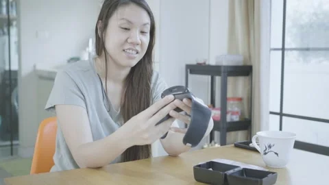 Exploring Technology: A Woman Interacting with a Device Stock Footage 313880325