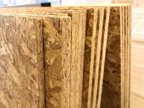 Exploring the texture and layers of engineered wood in a workshop setting Stock Photos