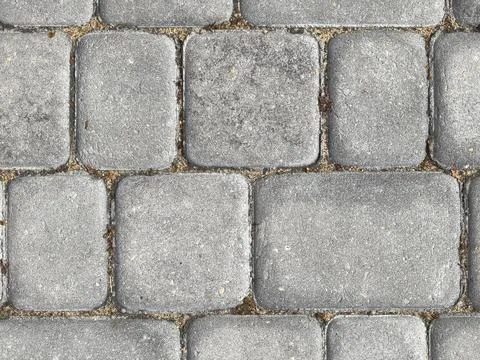 Exploring the texture and patterns of an old cobblestone path in sunlight Stock Photos