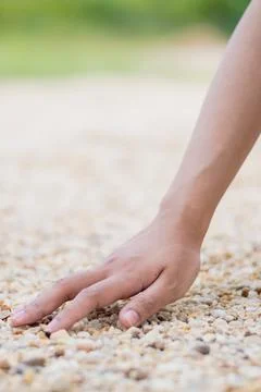 Exploring texture and touch hand pebbles outdoor setting close-up natural e.. Stock Photos