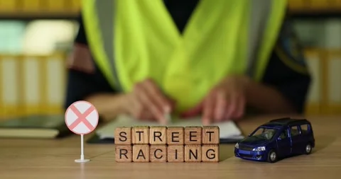 Exploring the thrills and risks of street racing with toy cars and caution signs Stock Footage 320183167