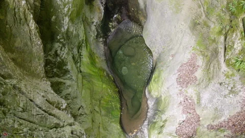 Exploring the tranquil pool in the rocky canyon with soothing water flow Stock Footage 318158739