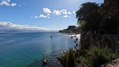 Exploring the tranquil shores of Corfu, Greece on a sunny day with sailing boats 動画素材 285596266