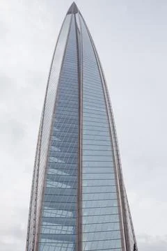 Exploring the Unique Architectural Design of Lakhta Center Against a Cloudy Sky Stock Photos