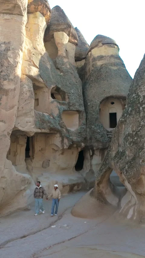Exploring unique cave dwellings in Cappadocia, Turkey during a sunny day Stock Footage 341482772