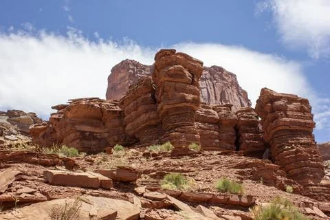Exploring unique rock formations in a scenic desert landscape under a brigh.. Stock Photos