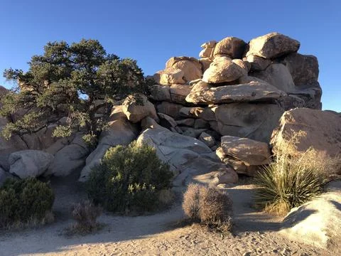 Exploring Unique Rock Formations Under a Vibrant Blue Sky at Sunset Stock Photos