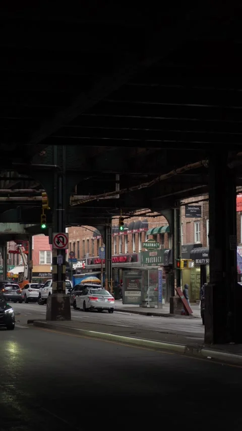 Exploring the Urban Landscape Below the Elevated Train Tracks in a Bustling City Stock Footage 291023915