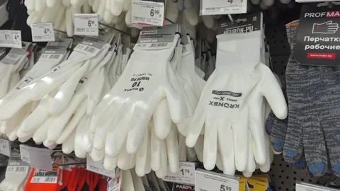 Exploring a variety of gloves in a hardware store aisle Stock Footage 335453001