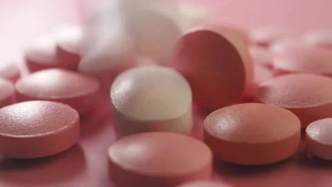 Exploring the variety of tablets on a pink surface 스톡 동영상 313315429