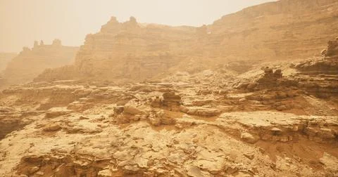 Exploring the vast and rugged terrain of a desert landscape under hazy skies Stock Illustration