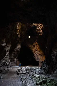 Exploring a Vast Dark Cave Stock Photos