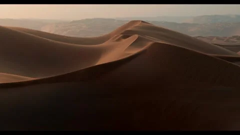 Exploring vast sand dunes during golden hour in the desert Video stock 320293403