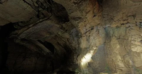 Exploring a vast underground cave with stunning rock formations at dusk Stock Illustration