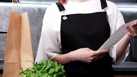 Exploring a vibrant cafe menu while enjoying a cozy afternoon in the city 스톡 동영상 296315646