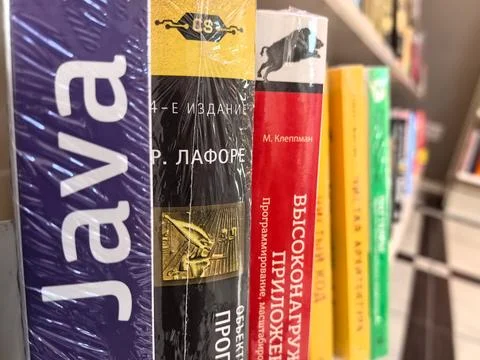 Exploring a vibrant collection of programming books on a sunny day Stock Photos