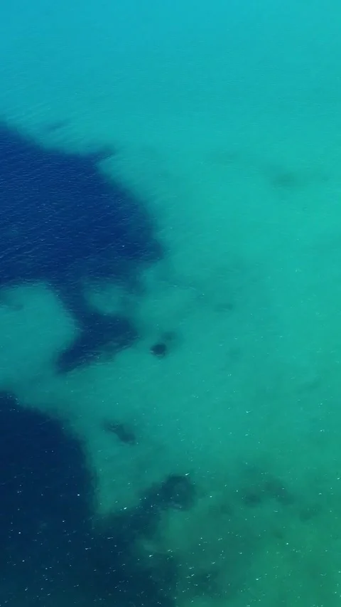 Exploring the Vibrant Colors of the Ocean Displaying Mysterious Shadows and Stock Footage 311111875