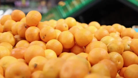 Exploring vibrant oranges at the local market during a sunny afternoon Stock Footage 296146776