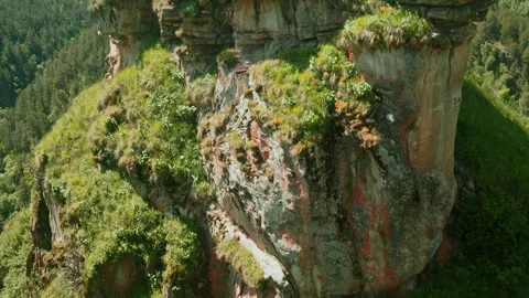 Exploring vibrant rock formations and lush greenery in a remote mountain region Video stock 313106455