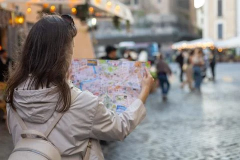 Exploring vibrant streets while navigating a charming old town with a city map Stock Photos