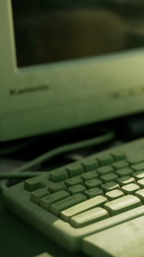Exploring vintage technology with a classic keyboard and computer setup Stock Footage 331839975