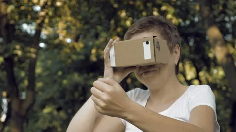 Exploring virtual reality in cardboard VR glasses Stock Footage 66725964
