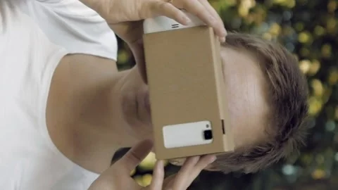 Exploring virtual reality in cardboard VR glasses Stock-Footage 91142619