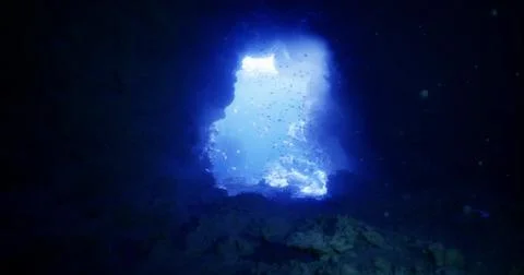 Exploring the vivid blue waters of an underwater cave during daylight Stock Illustration
