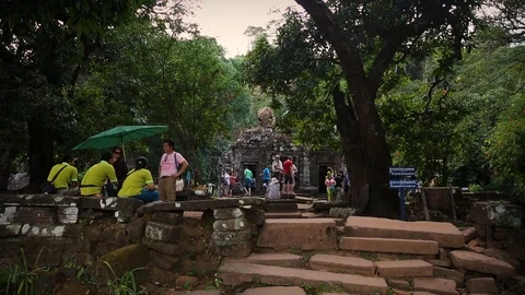 Exploring Wat Phu temple while the guides rest in Laos Stock Footage 104120123