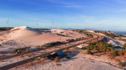 Exploring the white sand dunes in binh thuan vietnam with wind turbines and Stockbeeldmateriaal 333430616