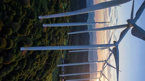 Exploring wind turbines during sunset at a renewable energy site in a scenic lan Stock Footage 296191184