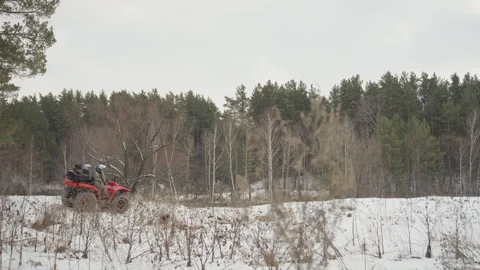 Exploring winter wilds via ATV. Remote countryside adventure with snowcovered Stock Footage 346251315