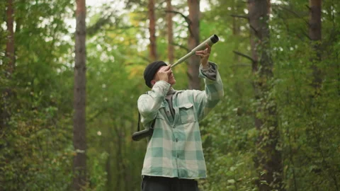 Exploring woods with survival tools, Hiker demonstrates safety and signal Stock Footage 327755503