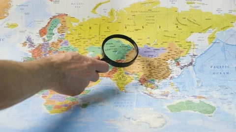 Exploring the world on a paper map Stock Footage 151114752