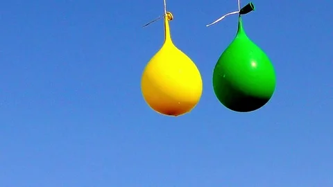 Explosion of balloon full of water on sky background, Full HD video 4 Stock Footage 82277652