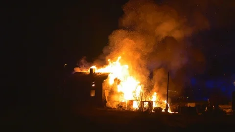 Explosion in burning house causing a huge burst of fire to shot out from the Stockbeeldmateriaal 92815791