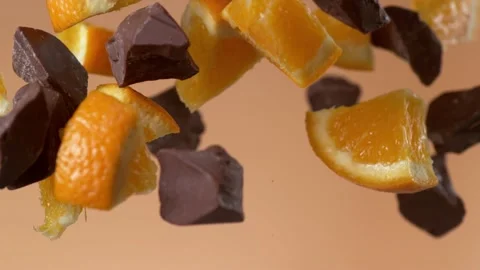 Explosion of chocolate chunks and orange slices. 4K footage Stock Footage 232316798