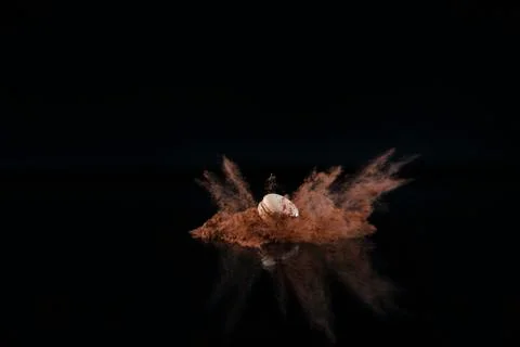 Explosion of cocoa powder with a macaron Stock Photos