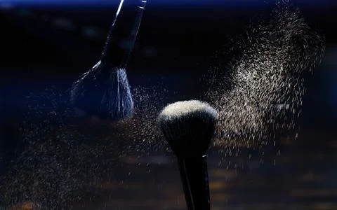 Explosion of eyeshadows on dark background. makeup brushes Stock Photos