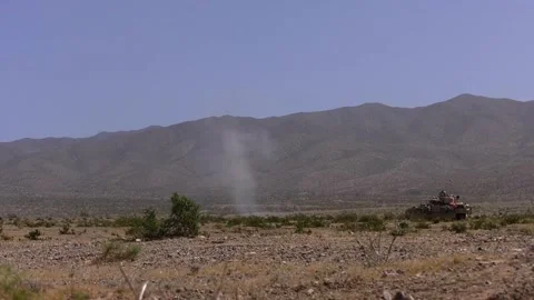 Explosion in Front of a Tank in a Desert Stock Footage 130360787