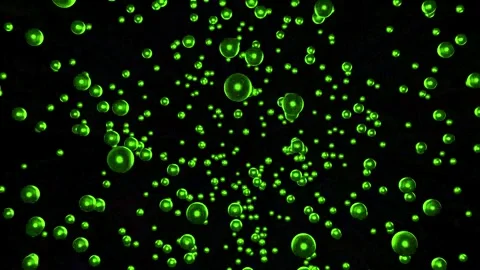 An explosion of green balls on a black background, the balls fly apart. Stock Footage 250544419