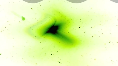 An explosion of green light, spreading dust particles on a bright backgroun.. Stock Footage 251313848