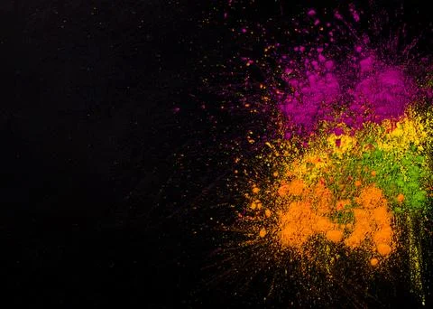 Explosion holi colors dark background Stock Photos