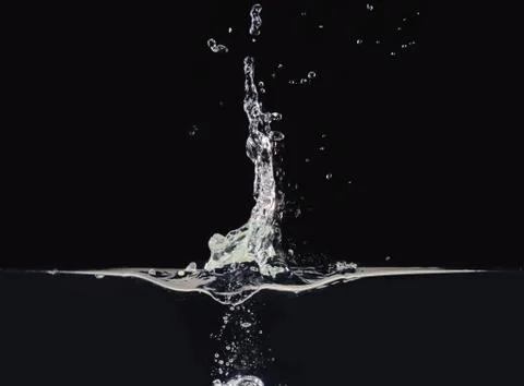 Explosion on liquid surface isolated on black background, close up view. Water Foto stock