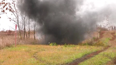 Explosion of a mine in a field. Close-up. After the explosion, a cloud of black Stock-Footage 220072126